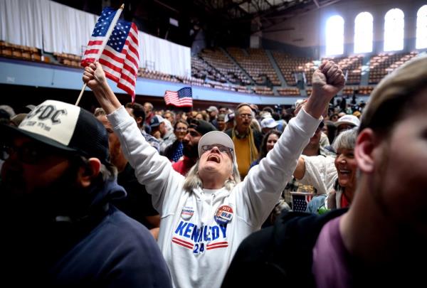 A supporter cheers for Independent presidential candidate Robert F. Kennedy Jr. as he speaks during a campaign event to announce his pick for a running mate at the Henry J. Kaiser Event Center in Oakland, California, on March 26, 2024. Independent US presidential candidate Robert F. Kennedy Jr. announced wealthy Silicon Valley lawyer and political newcomer Nicole Shanahan as his running mate March 26, 2024, as he pursues an anti-establishment campaign seen as an increasing threat to Democrat Joe Biden.
